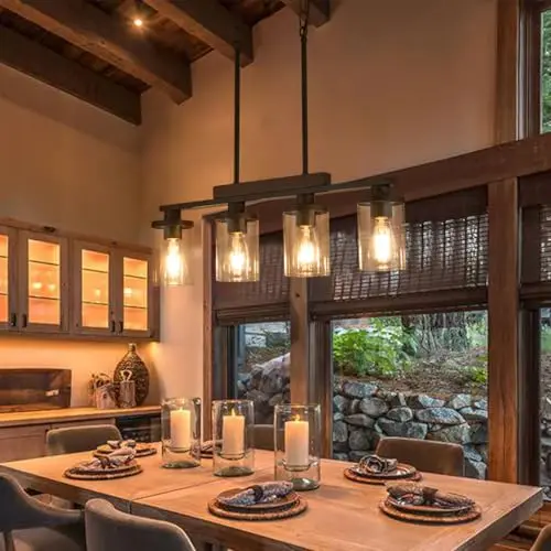 TWIG 4-light matte black farmhouse chandelier with wood and clear glass shades over a dining table